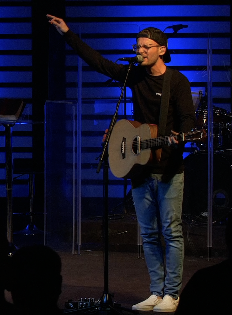 Jake Gritten performing during worship.