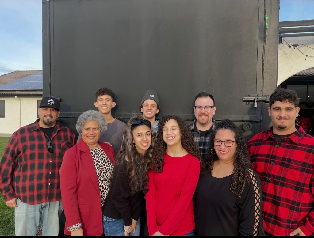 Rios family posing together outdoors, smiling for a group photo