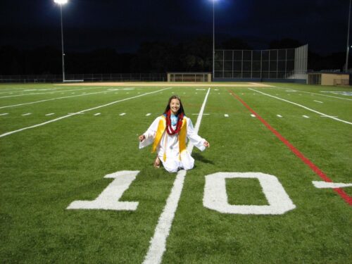 Lyndsey Guerrero sitting on football field