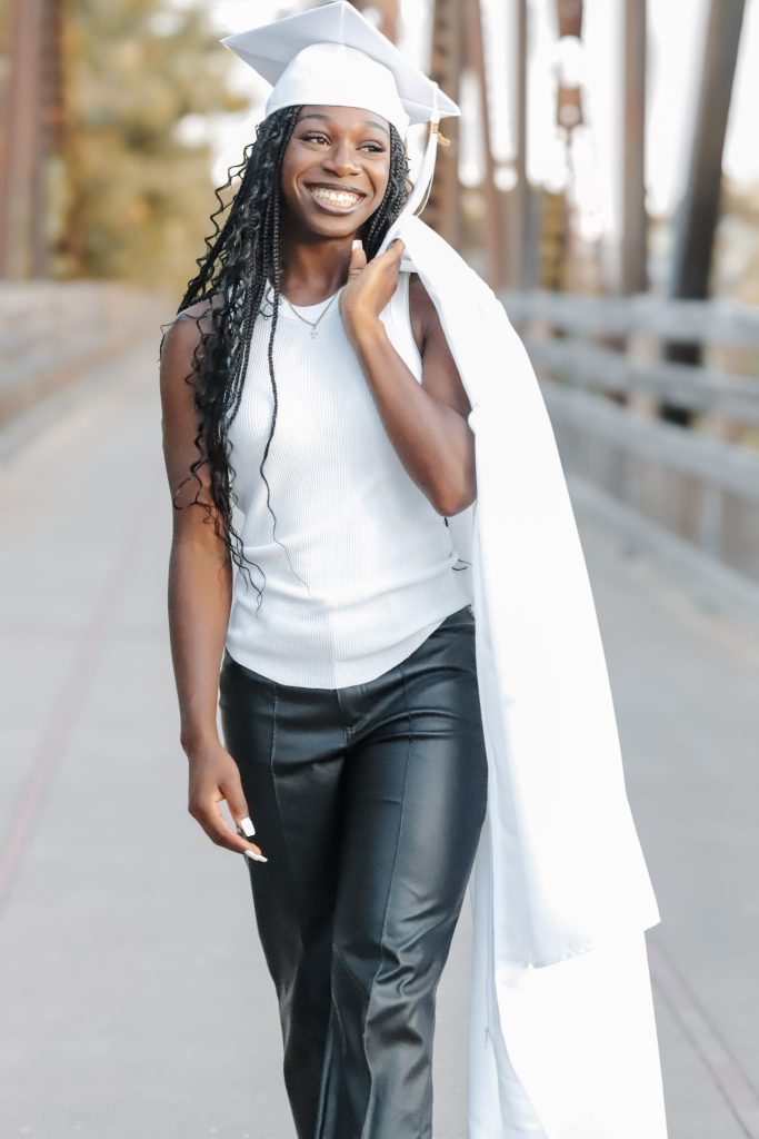 Danielle Ruff, Vacaville Christian School Class of 2026 graduate, smiles while walking with her graduation cap and gown, celebrating before continuing her basketball career at Solano College.